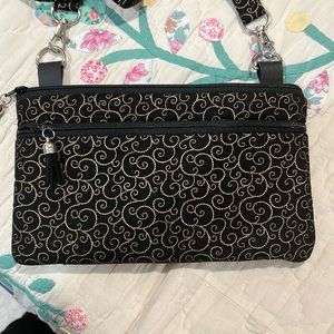Black and gold cross body with removable straps and tassels to zipper sections